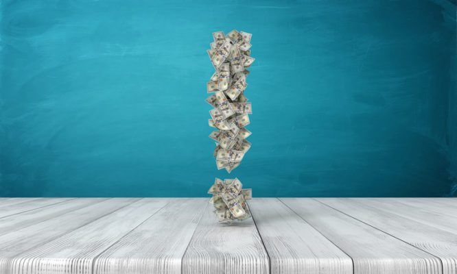 3d rendering of an exclamation sign made of many dollar bills hovering over a wooden desk. 