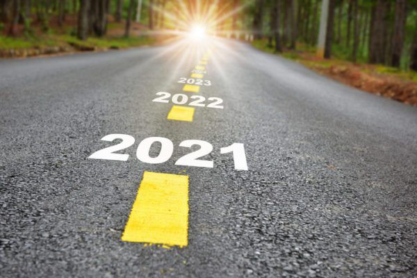 New year journey 2021 to 2024 on asphalt road surface with marking lines and sunlight