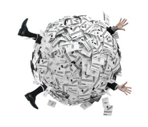 Person overwhelmed by a barrage of flying papers, symbolizing stress or information overload.