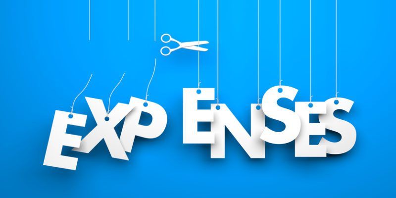 White word "expenses" suspended by ropes on blue background