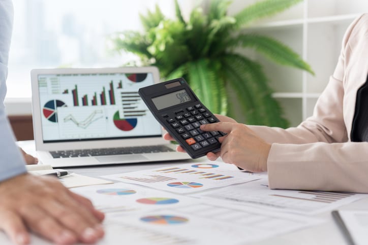 business women calculated financial figures during discussion with partner corporate so showing the results of business profits.