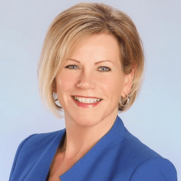 Pam Wallace, a professional woman in a blue blazer, smiling against a plain background.