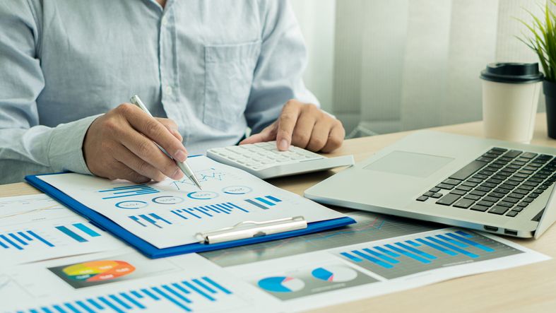 Businessman with pen pointing to graph, financial data, research, develop, market report.