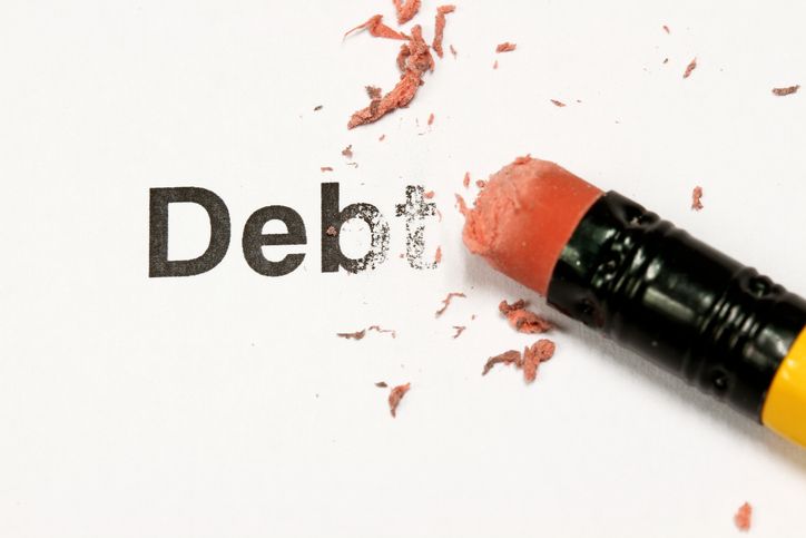 eraser and word debt concept of Reduce Debt. Maximize cash flow wihtout relying on debt.