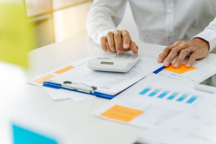 Business person calculating working capital. Working capital formula.