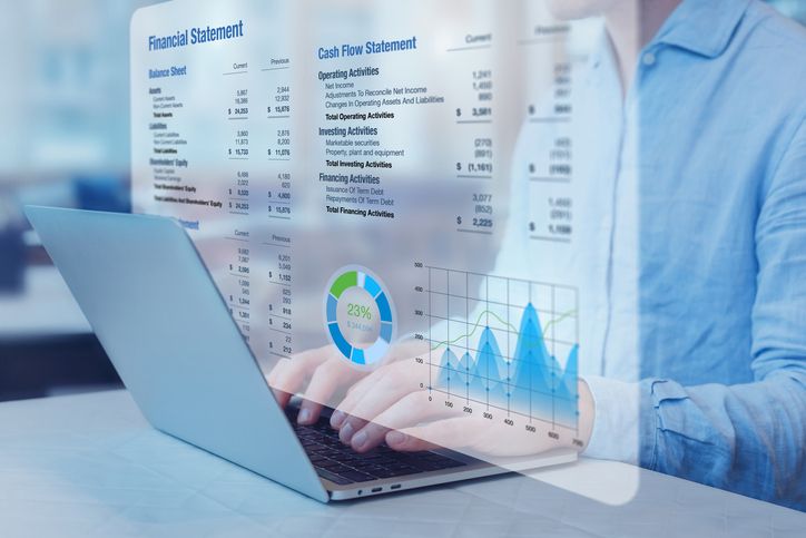 Businessman analysing financial statements with graph on computer. Auditing balance sheet, sales and income report, business operations data, corporate accounts.