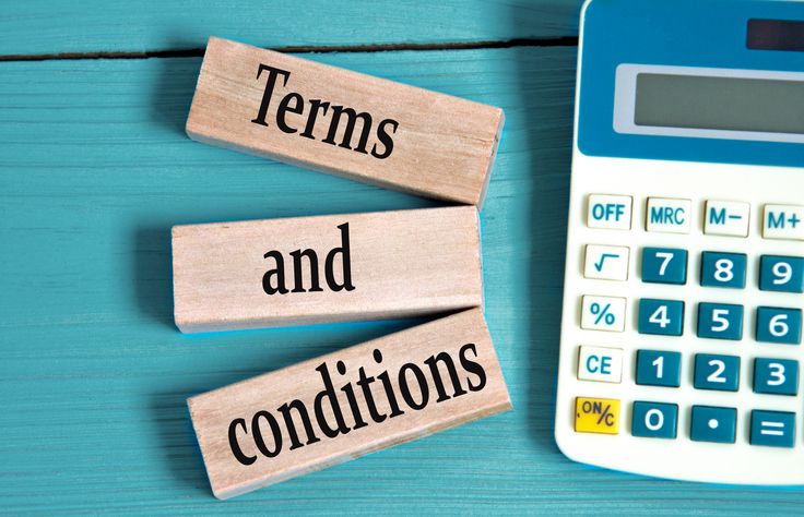 TERMS and CONDITIONS - words on wooden blocks with a calculator in the background. Business concept. Best practices for extending customer credit.