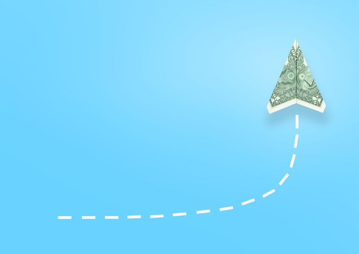 Conceptual one dollar bill plane rises up on blue background for improving cash flow.